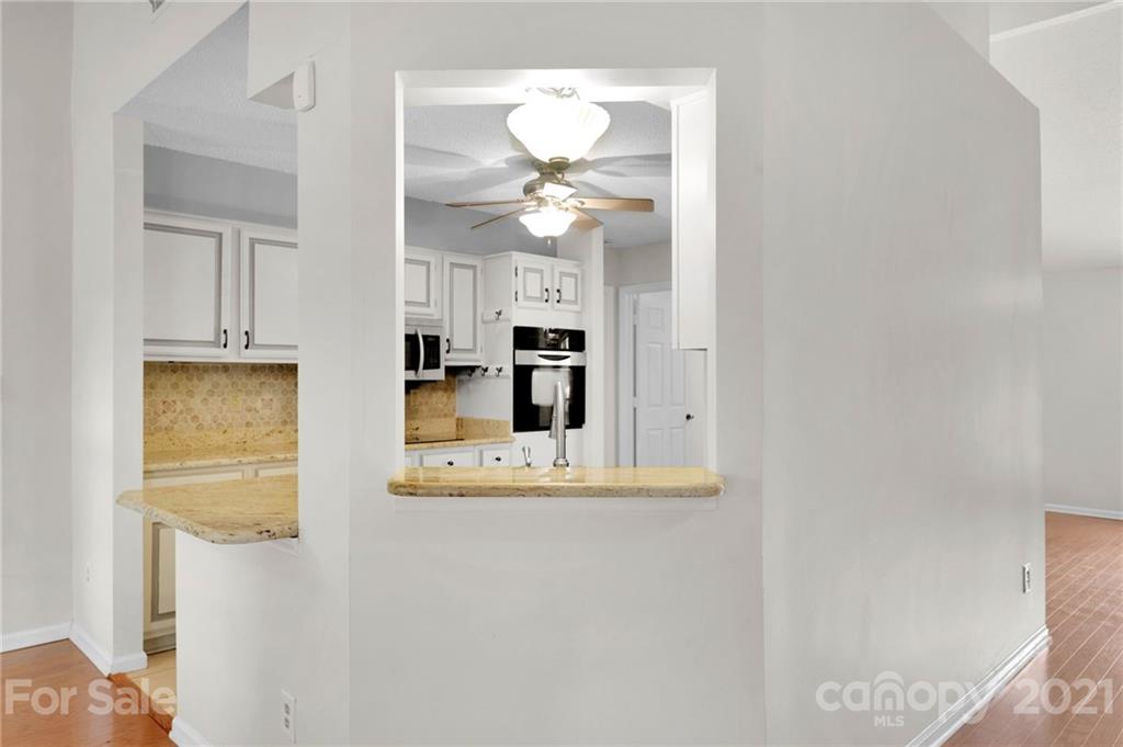 9838 Fairway Ridge Road, Unit 11 Charlotte, NC 28277 - Photo 13 of 40 a view of a kitchen with a sink and a chandelier fan