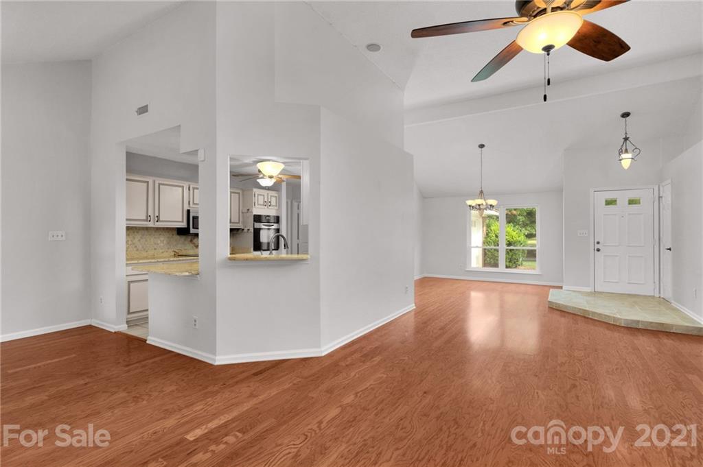 9838 Fairway Ridge Road, Unit 11 Charlotte, NC 28277 - Photo 14 of 40 a view of empty room with wooden floor and window