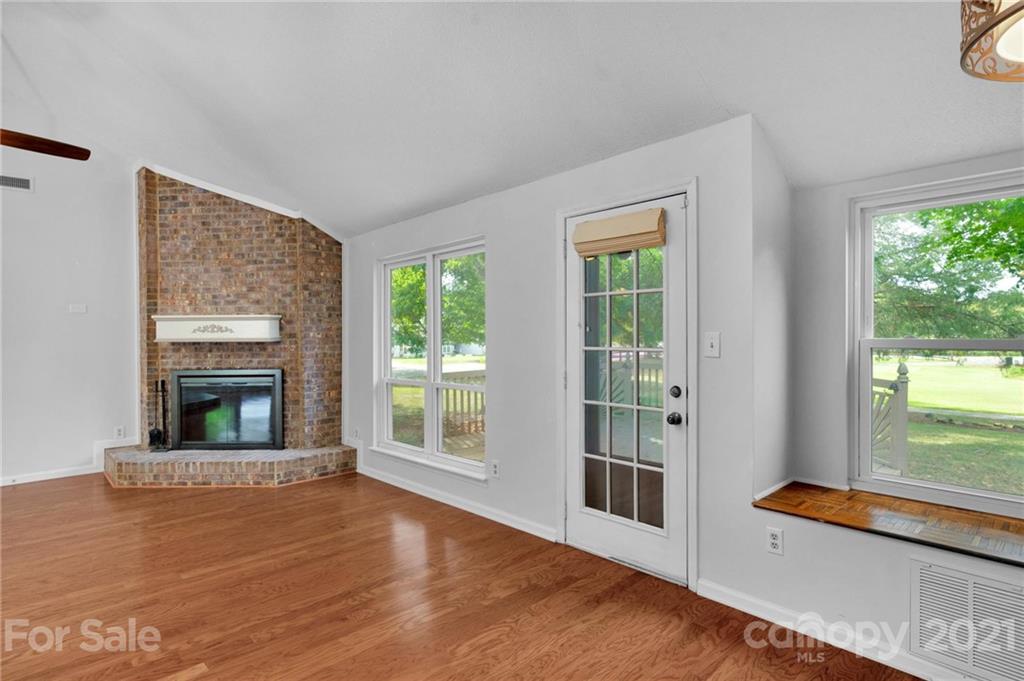 9838 Fairway Ridge Road, Unit 11 Charlotte, NC 28277 - Photo 16 of 40 a view of an empty room with glass door and wooden floor