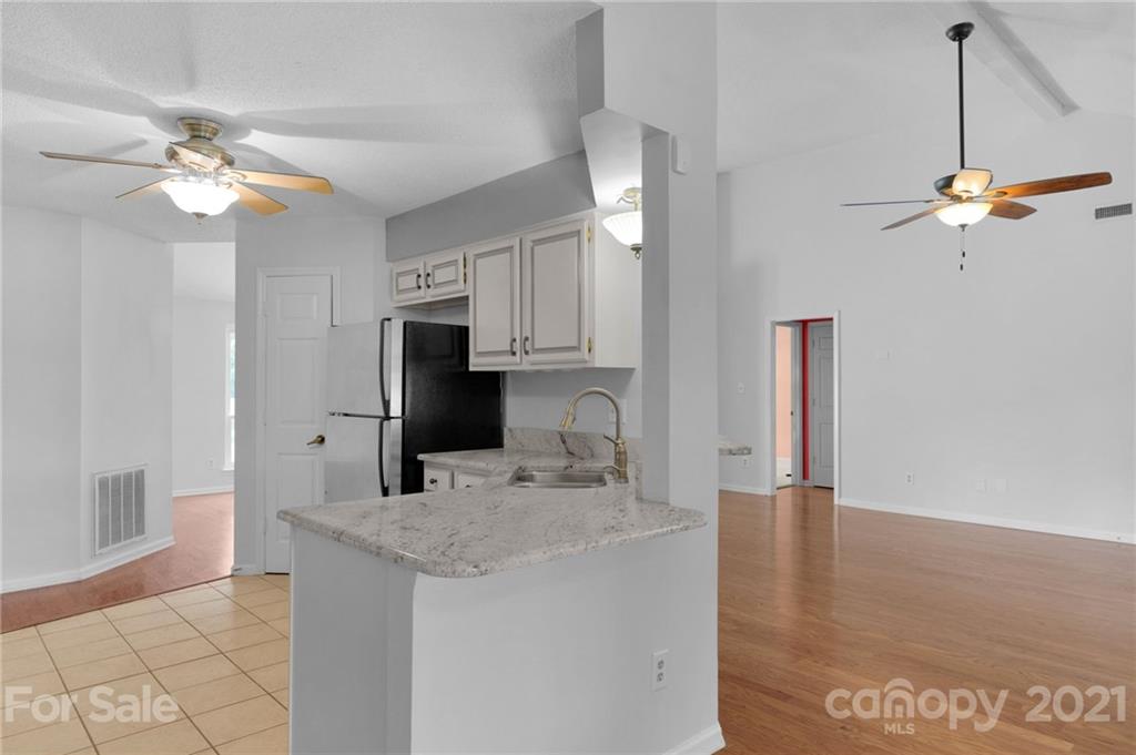 9838 Fairway Ridge Road, Unit 11 Charlotte, NC 28277 - Photo 17 of 40 a kitchen with granite countertop a sink a counter top space appliances and cabinets