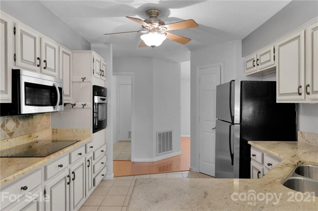9838 Fairway Ridge Road, Unit 11 Charlotte, NC 28277 - Photo 18 of 40 a kitchen with stainless steel appliances granite countertop a refrigerator a stove and a sink