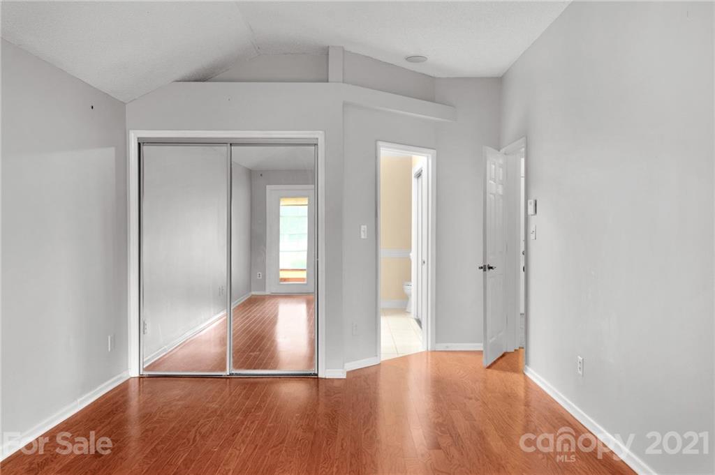 9838 Fairway Ridge Road, Unit 11 Charlotte, NC 28277 - Photo 23 of 40 a view of a livingroom with wooden floor and closet