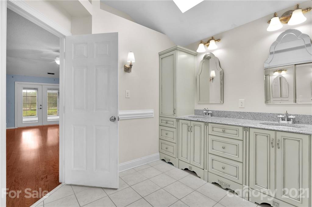 9838 Fairway Ridge Road, Unit 11 Charlotte, NC 28277 - Photo 25 of 40 a bathroom with a double vanity sink and a mirror