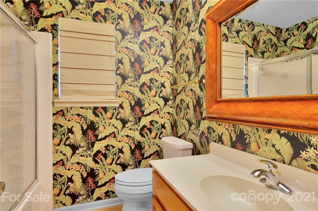 9838 Fairway Ridge Road, Unit 11 Charlotte, NC 28277 - Photo 26 of 40 a bathroom with a sink and mirror with toilet