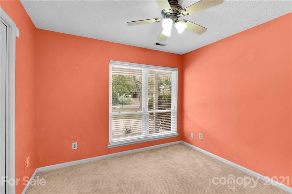 9838 Fairway Ridge Road, Unit 11 Charlotte, NC 28277 - Photo 27 of 40 an empty room with a window and a ceiling fan