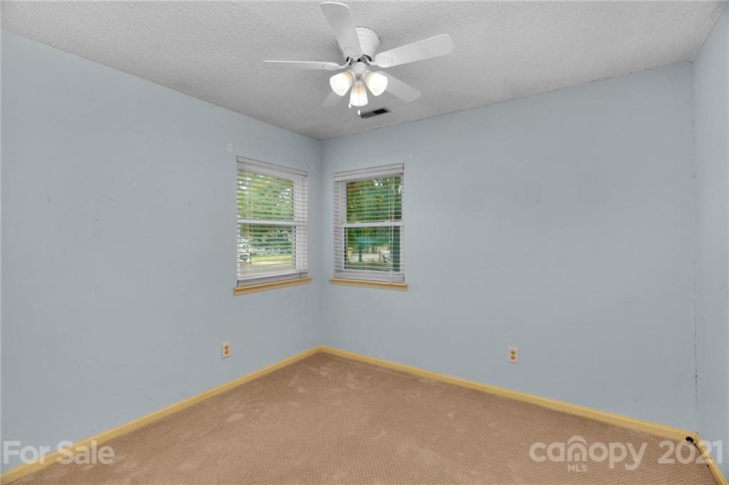 9838 Fairway Ridge Road, Unit 11 Charlotte, NC 28277 - Photo 28 of 40 an empty room with windows and ceiling fan