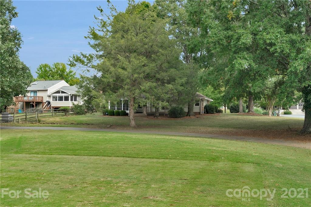9838 Fairway Ridge Road, Unit 11 Charlotte, NC 28277 - Photo 37 of 40 a front view of a house with a yard