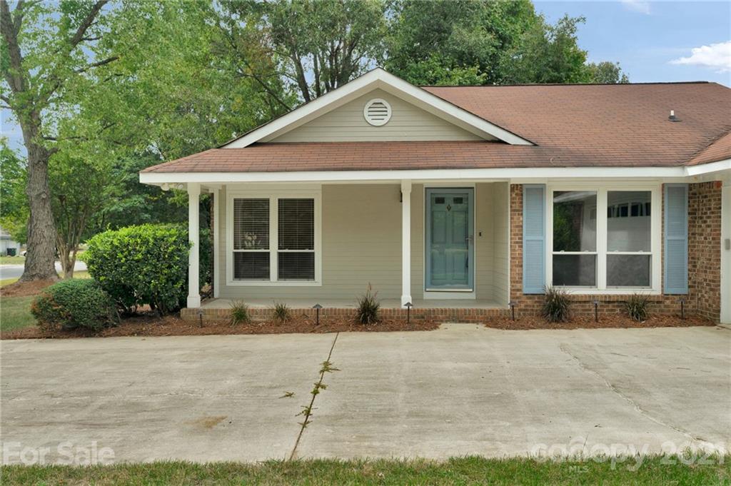 9838 Fairway Ridge Road, Unit 11 Charlotte, NC 28277 - Photo 5 of 40 a front view of a house with a yard and garage