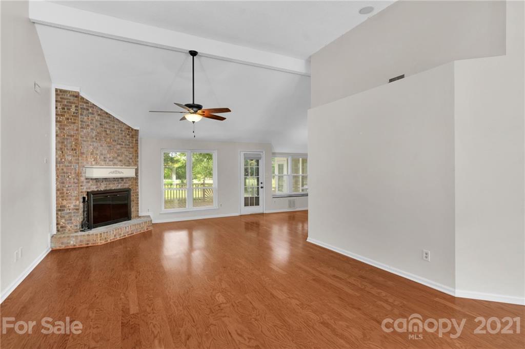 9838 Fairway Ridge Road, Unit 11 Charlotte, NC 28277 - Photo 6 of 40 a view of an empty room with a window and fireplace