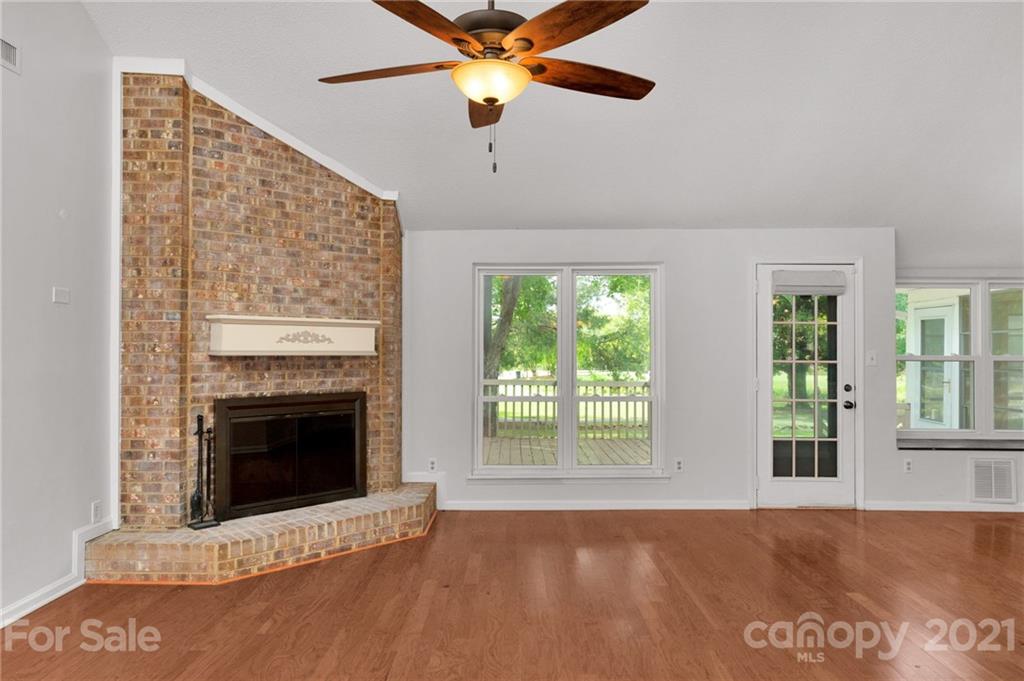 9838 Fairway Ridge Road, Unit 11 Charlotte, NC 28277 - Photo 7 of 40 a view of an empty room with window and fireplace