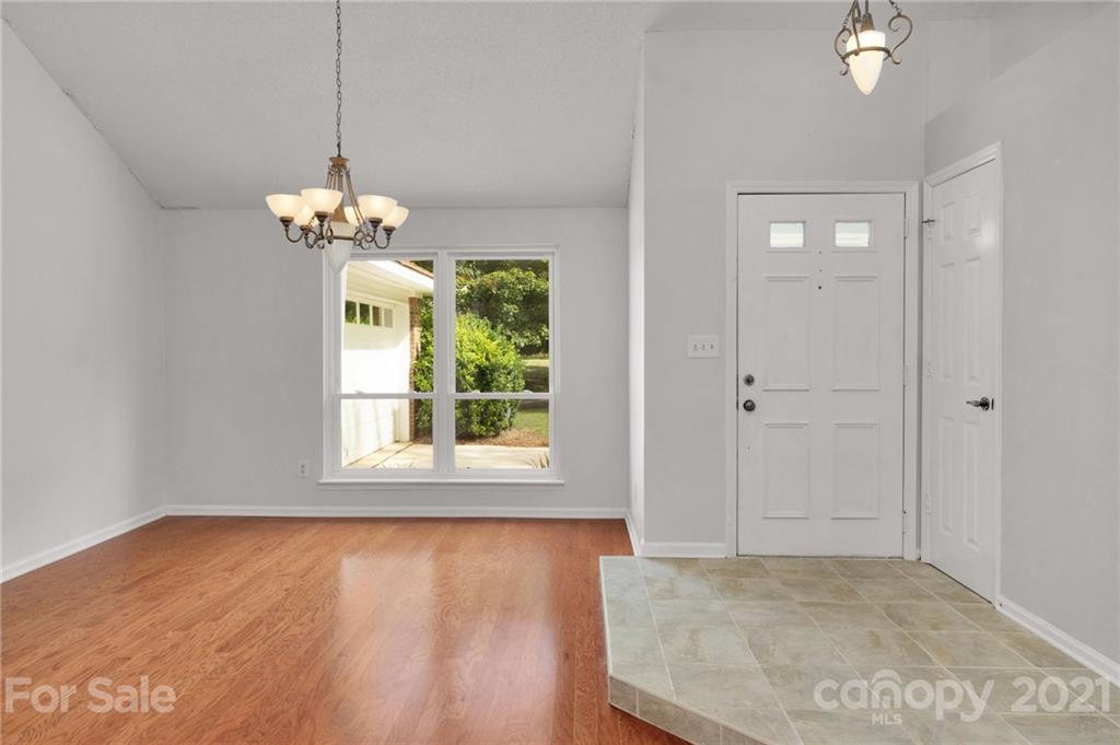 9838 Fairway Ridge Road, Unit 11 Charlotte, NC 28277 - Photo 8 of 40 wooden floor in an empty room with a window