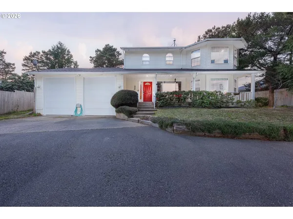 a front view of a house with a yard and garage