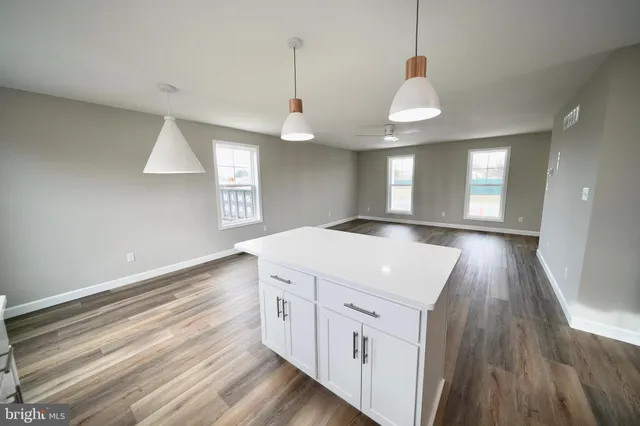 a room with wooden floor and windows