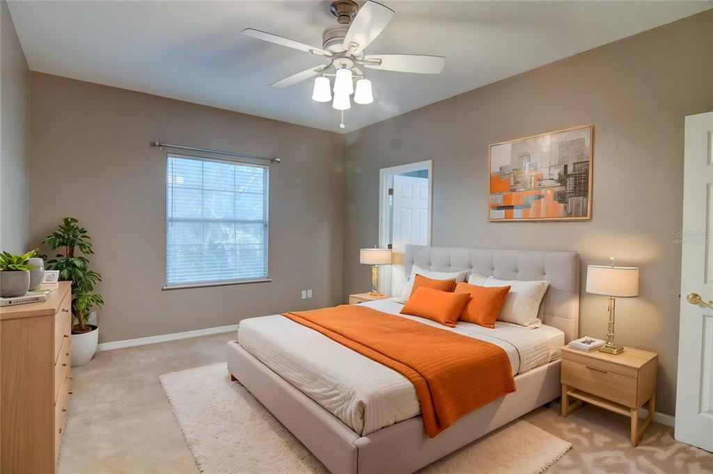 4933 Northwest 1st Place, Unit 110 Gainesville, FL 32607 - Photo 13 of 31 a bedroom with a large bed and a chandelier