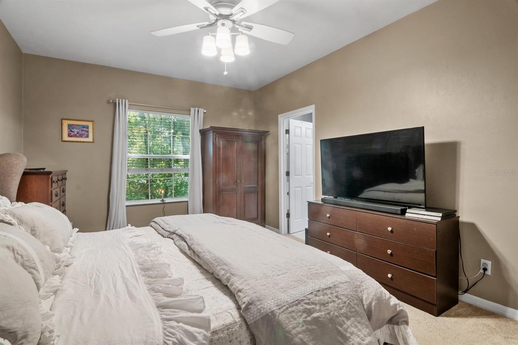 4933 Northwest 1st Place, Unit 110 Gainesville, FL 32607 - Photo 18 of 31 a bedroom with a bed and a flat screen tv