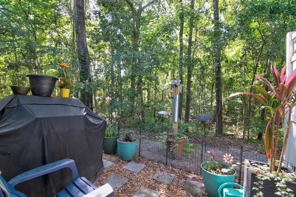 4933 Northwest 1st Place, Unit 110 Gainesville, FL 32607 - Photo 27 of 31 a view of a backyard with garden and plants
