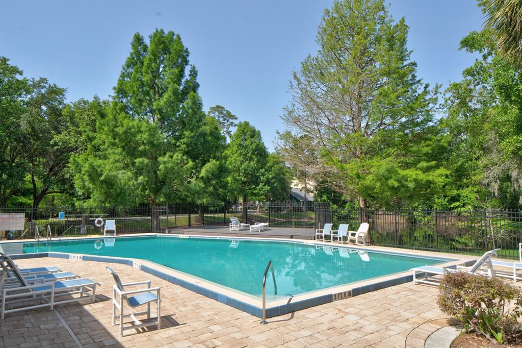 4933 Northwest 1st Place, Unit 110 Gainesville, FL 32607 - Photo 28 of 31 a view of a tennis ground with large trees