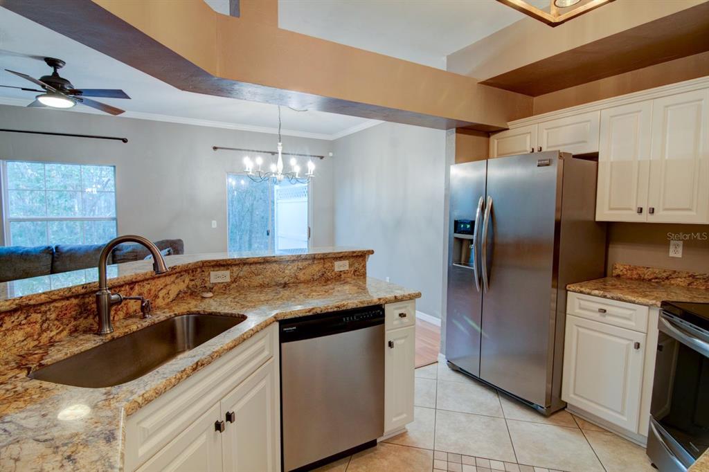 4933 Northwest 1st Place, Unit 110 Gainesville, FL 32607 - Photo 4 of 31 a kitchen with stainless steel appliances granite countertop a sink stove and refrigerator