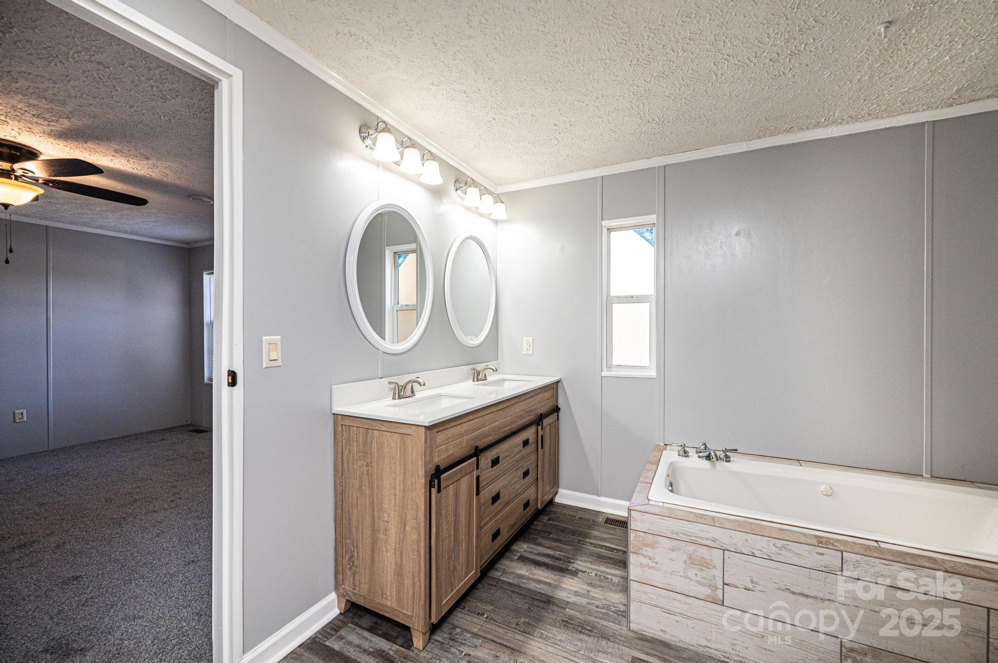 4086 Beckys Drive Lenoir, NC 28645 - Photo 12 of 23 a bathroom with a double vanity sink mirror and bathtub