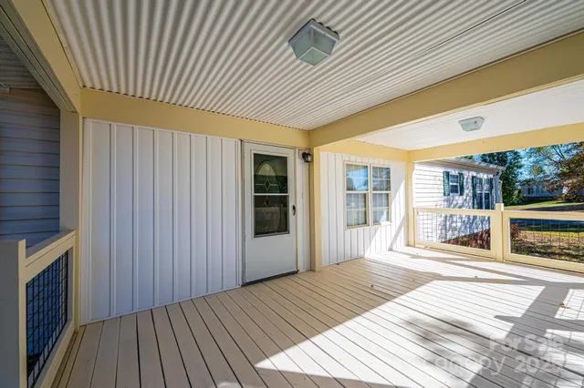a view of a kitchen with refrigerator and wooden floor