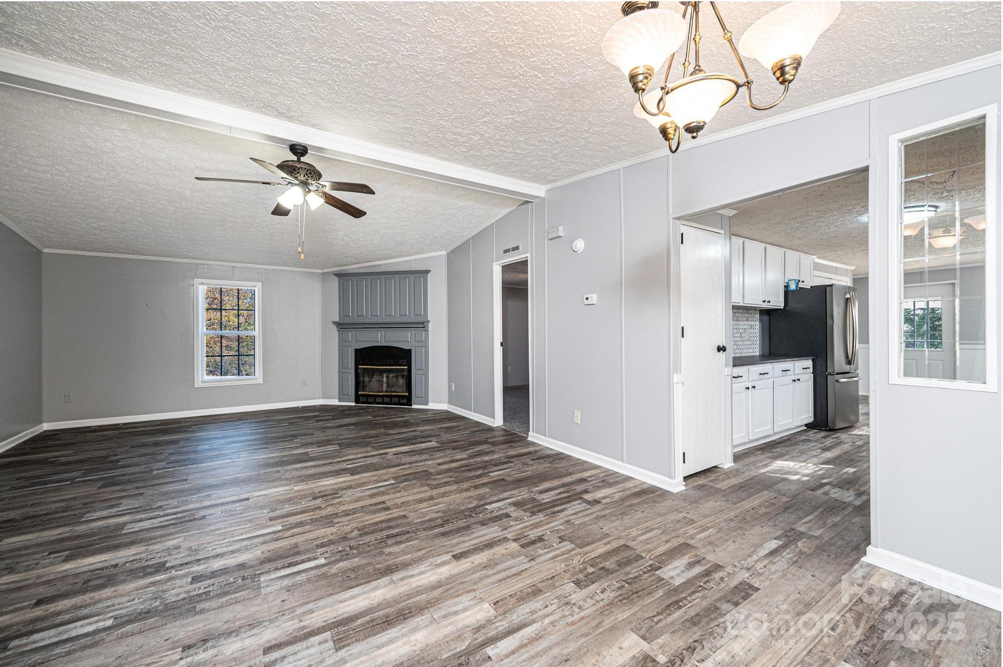 4086 Beckys Drive Lenoir, NC 28645 - Photo 6 of 23 a view of an empty room with a kitchen and a window