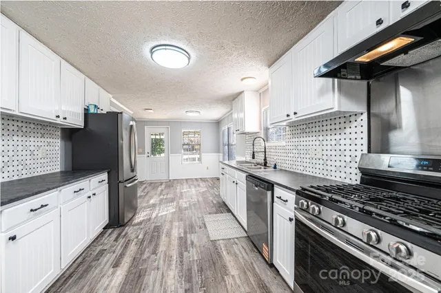 a view of yard with swimming pool and trees