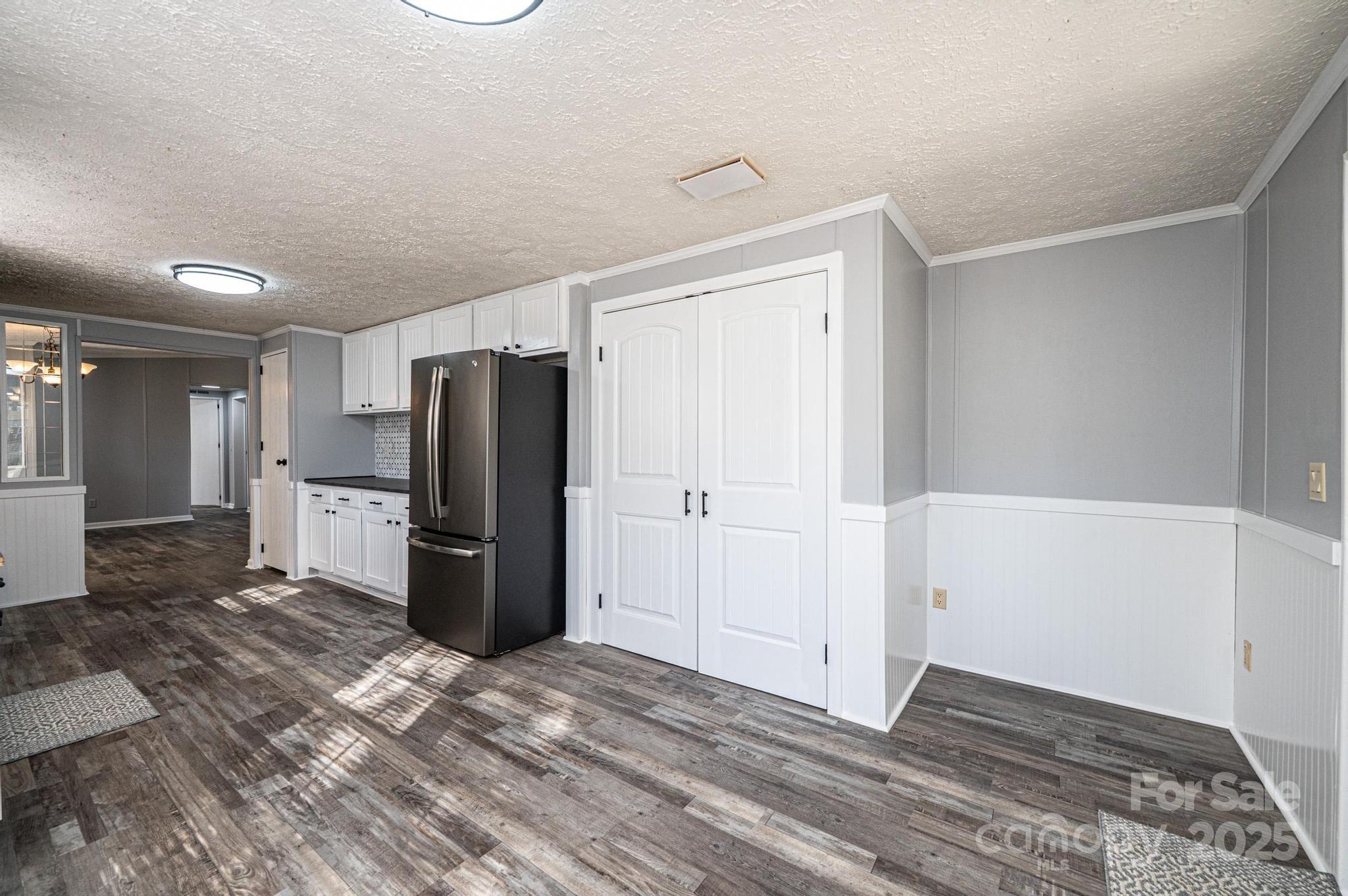 4086 Beckys Drive Lenoir, NC 28645 - Photo 10 of 23 a view of a kitchen with refrigerator and wooden floor