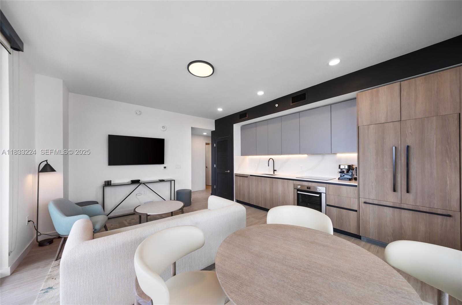 580 72nd Street, Unit 910 Miami Beach, FL 33141 - Photo 27 of 60 a hotel room with furniture and a flat screen tv