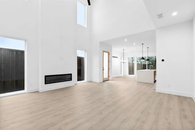 a view of an empty room with a kitchen