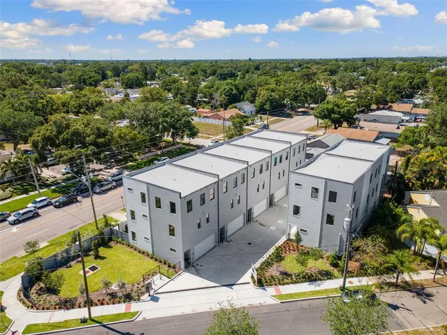an aerial view of residential houses with outdoor space and street view