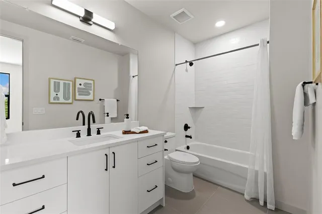 a bathroom with a tub sink toilet and a mirror