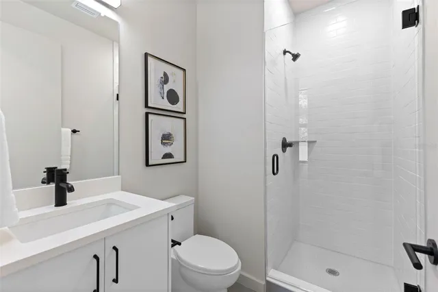 a bathroom with a shower sink and toilet