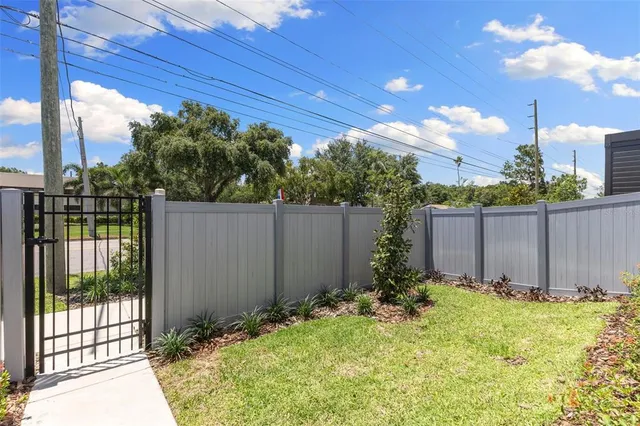 an aerial view of a city with lots of residential buildings ocean and mountain view in back