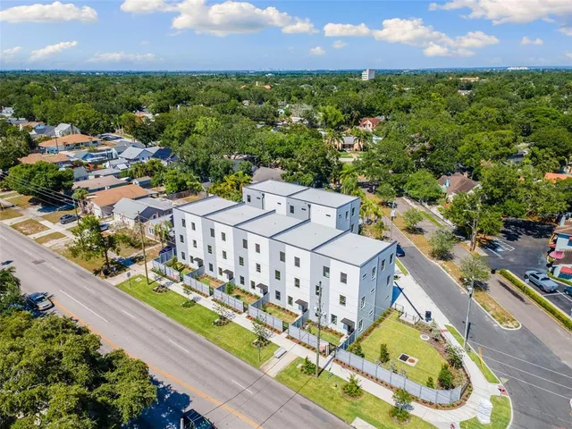 an aerial view of residential houses with outdoor space and street view