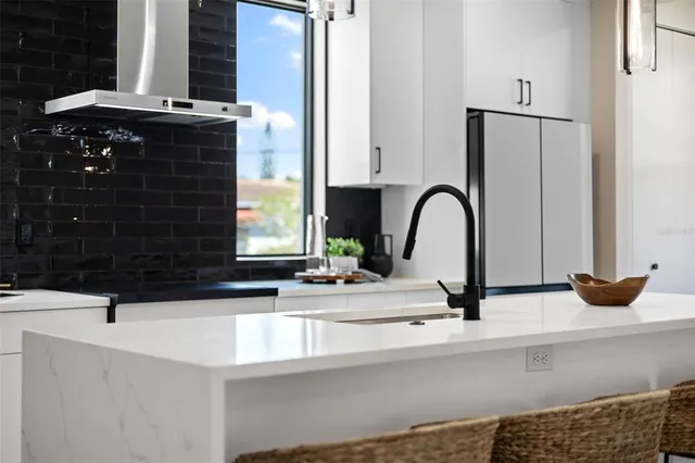 a large kitchen with white cabinets