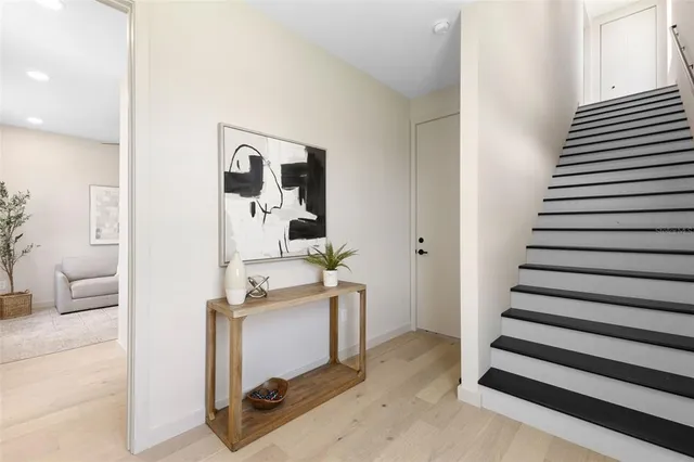 a view of a hallway with workspace and wooden floor