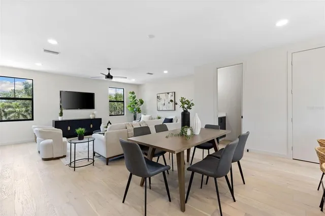 a living room with furniture and kitchen view