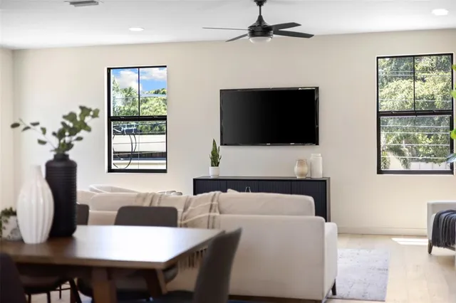 a living room with furniture and a potted plant