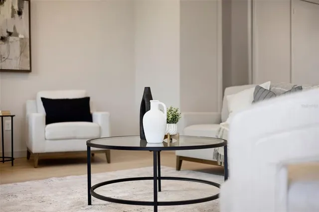 a living room with furniture a window and a flat screen tv