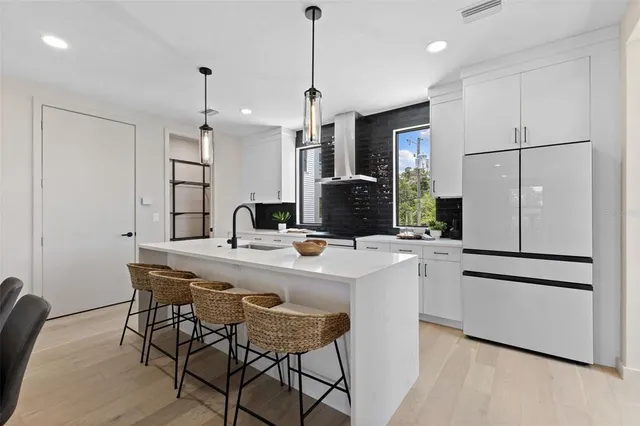a kitchen with stainless steel appliances a refrigerator and a stove top oven