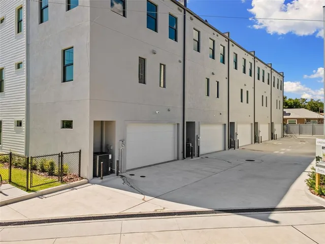 an aerial view of a houses with a yard