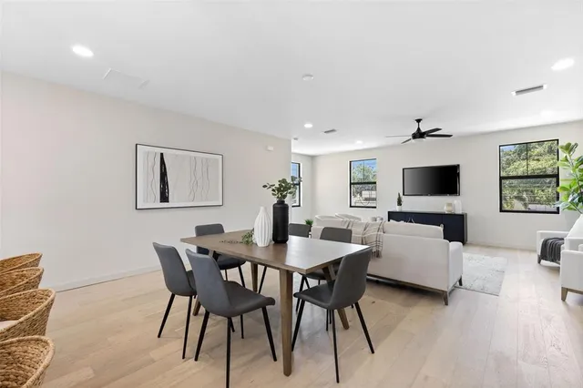 a view of a dining room with furniture and wooden floor