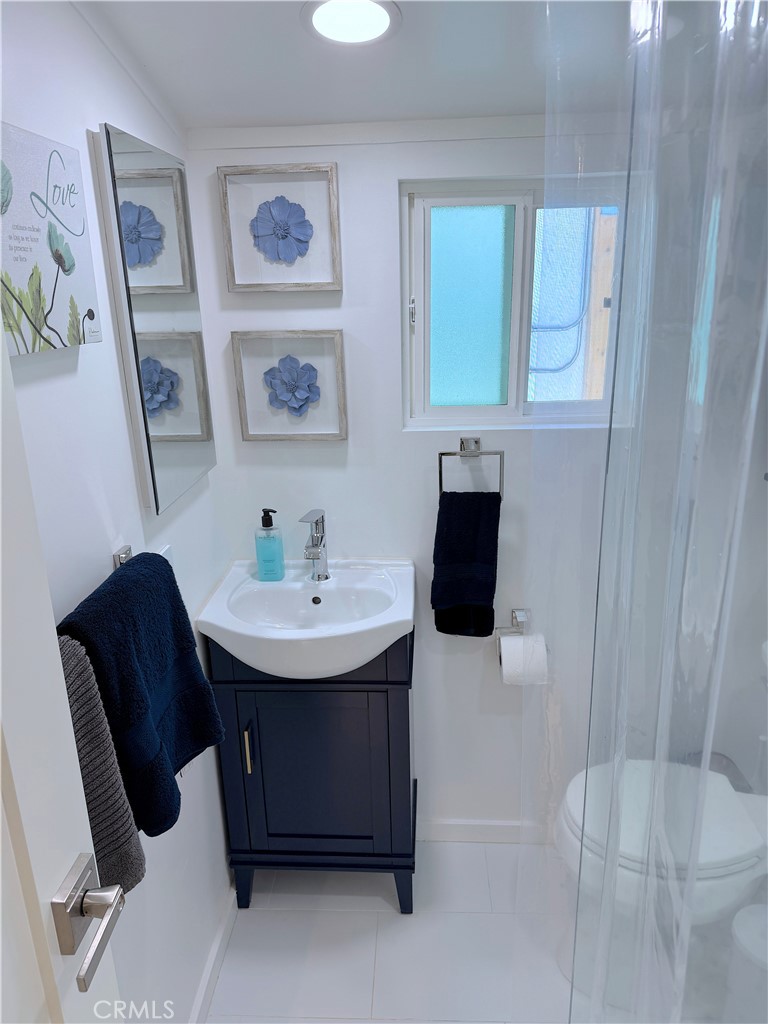 726 1/2 Esplanade Redondo Beach, CA 90277 - Photo 16 of 26 a bathroom with a sink toilet and a mirror