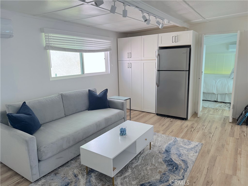 726 1/2 Esplanade Redondo Beach, CA 90277 - Photo 2 of 26 a living room with furniture and a refrigerator