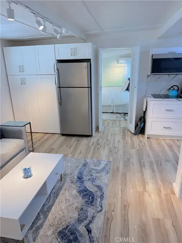 a kitchen with a refrigerator and a sink