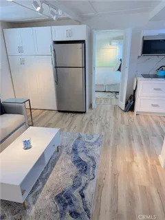 a kitchen with a sink and a refrigerator