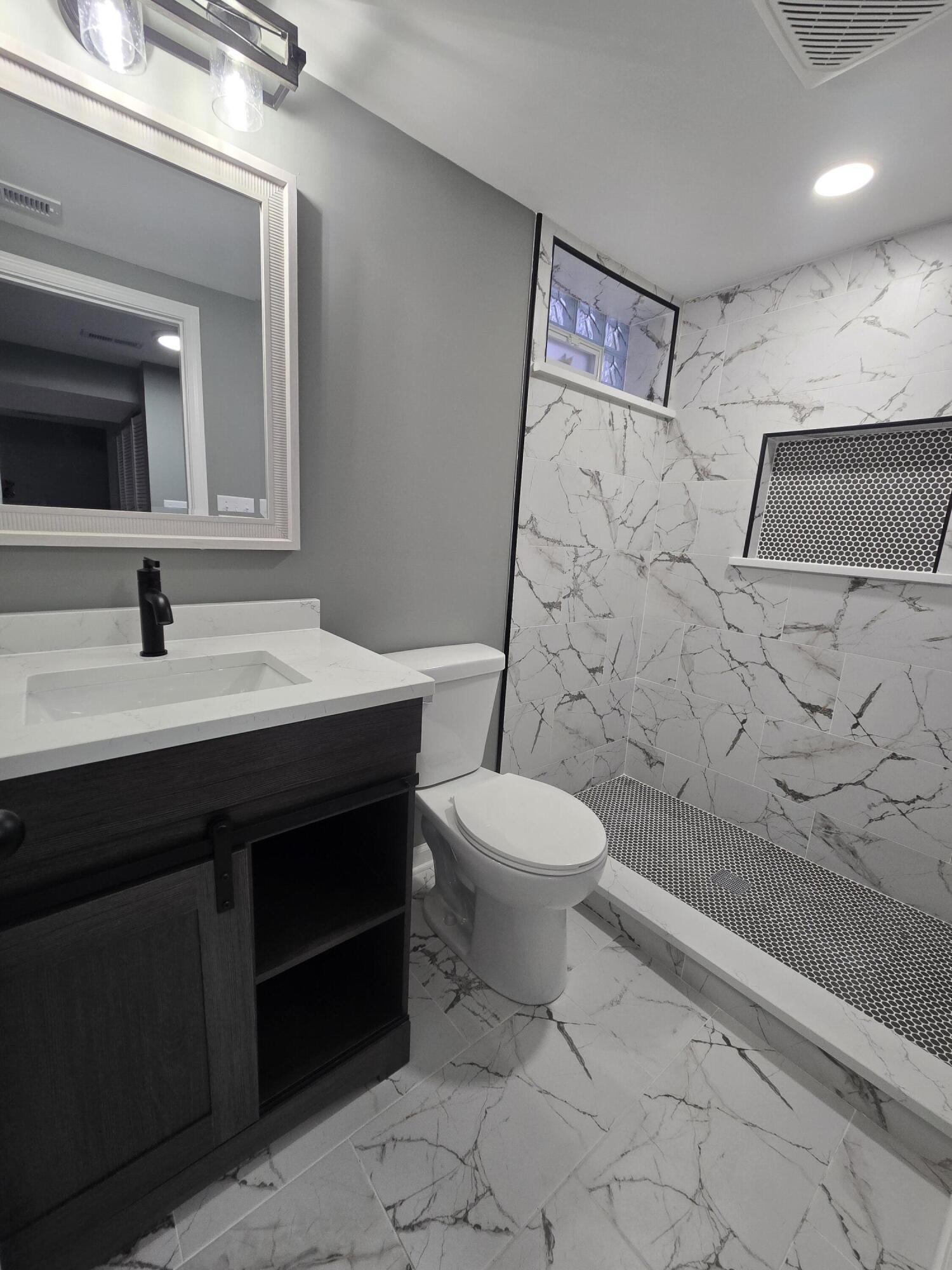 2100 West 2nd Avenue Gary, IN 46404 - Photo 18 of 22 a bathroom with a sink a toilet and shower