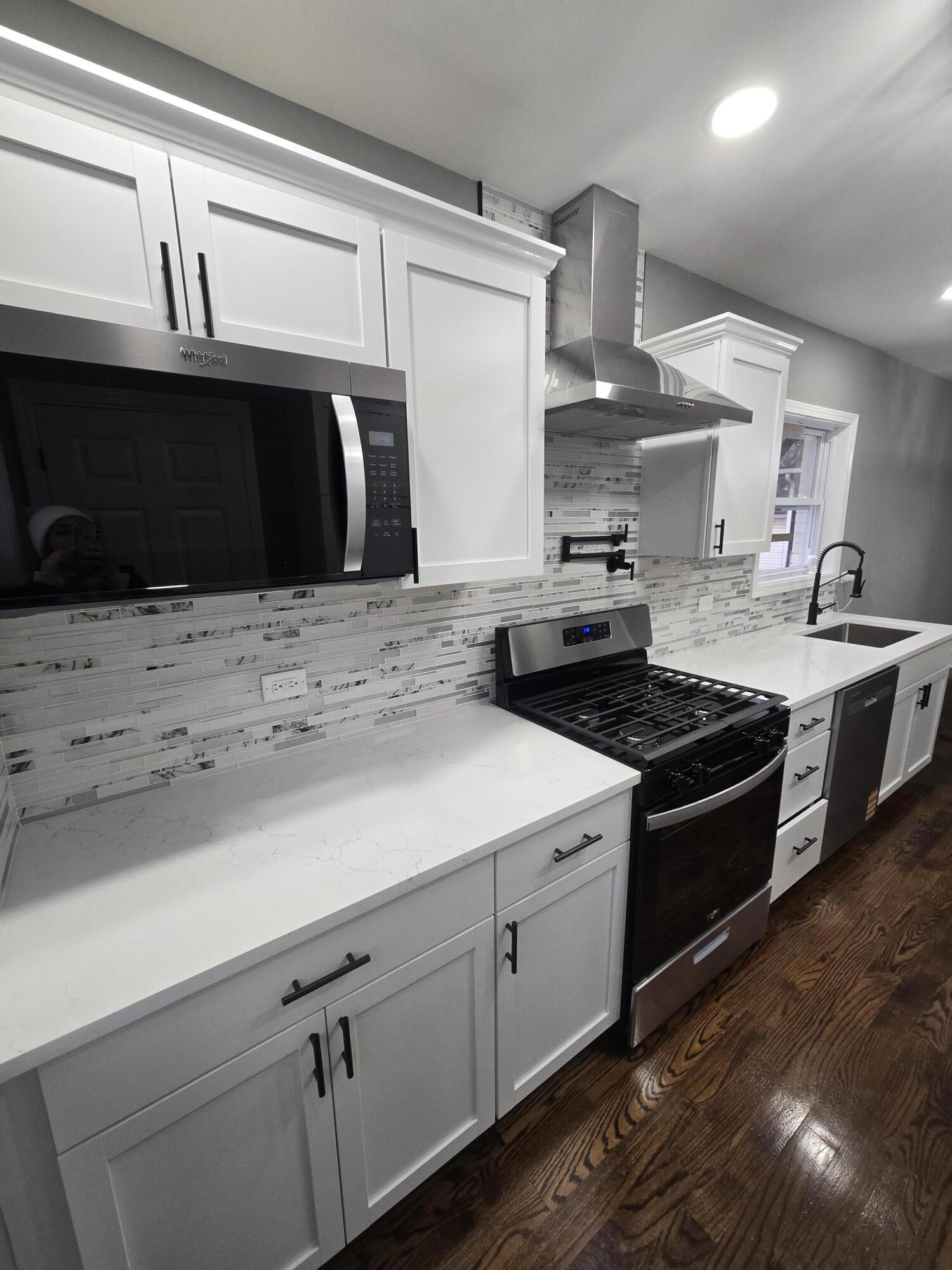 2100 West 2nd Avenue Gary, IN 46404 - Photo 6 of 22 a kitchen with stainless steel appliances granite countertop a stove a sink and a microwave