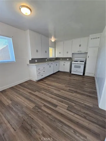 a view of a kitchen with wooden floor