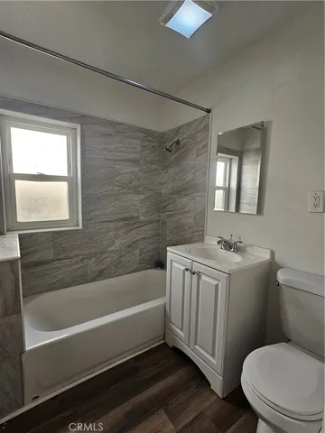 a bathroom with a sink a toilet and bathtub